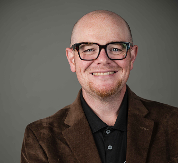 Jordy Jones poses with her laptop and her son on her lap.